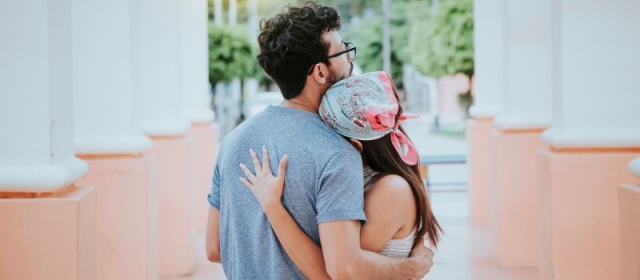 Man embracing woman