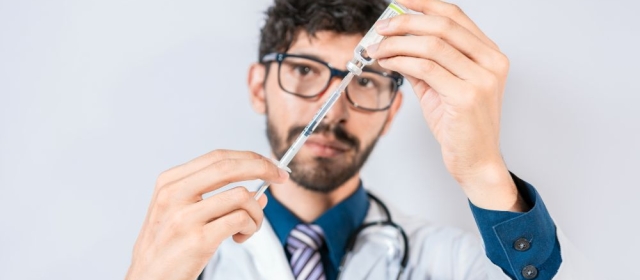 Man doctor drawing injection