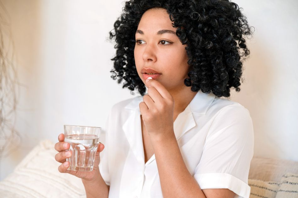 woman preparing to take medication