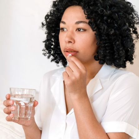 woman preparing to take medication