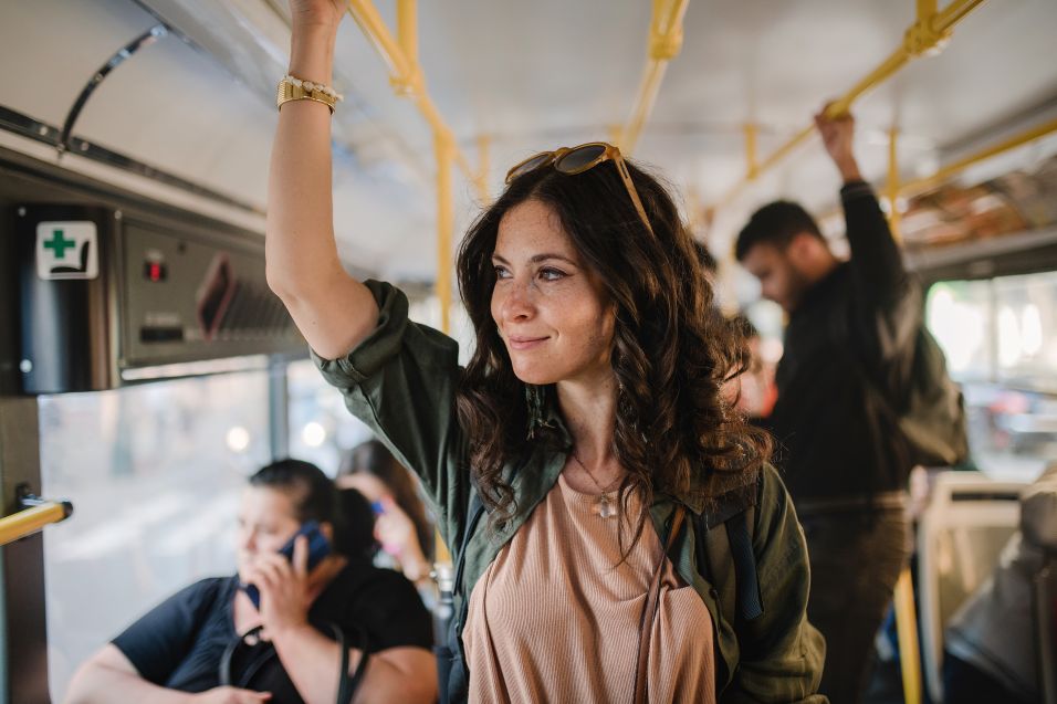 Woman standing on the bus