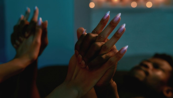couple holding hands in bed