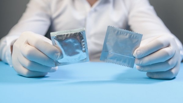 doctor holding unbranded condoms