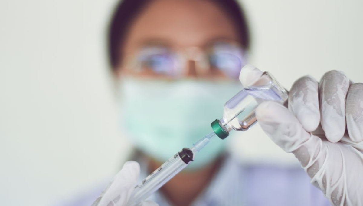 doctor filling a syringe